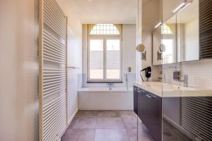 a bathroom with a sink and a window at Smartflats - Meir Antwerp in Antwerp