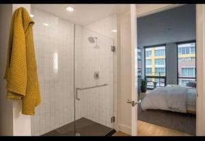 a bathroom with a shower and a bedroom with a bed at High Rise Luxury Apt DT San Diego with Great views 712 in San Diego