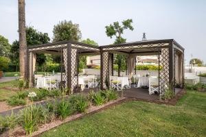 a wedding gazebo with tables and a cross on top at Laguna Park Hotel 4Superior in Bibione