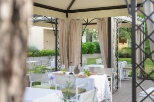 a table set up for a wedding under a tent at Laguna Park Hotel 4Superior in Bibione