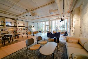 a living room with a couch and chairs and tables at Great apartment with view and heated rooftop Pool in Vienna