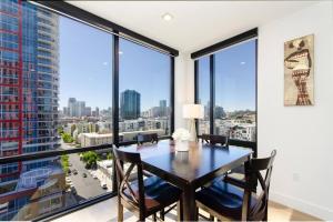 a dining room with a table and large windows at High Rise Luxury Apt DT San Diego with Great views 712 in San Diego