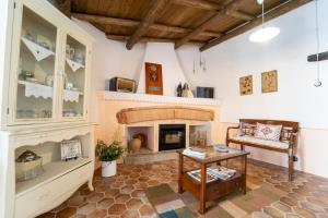 a living room with a fireplace and a table at Casa storica Austis, Sardegna in Austis