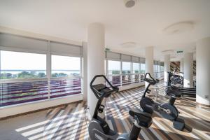 a gym with treadmills and ellipticals in a building at Laguna Park Hotel 4Superior in Bibione