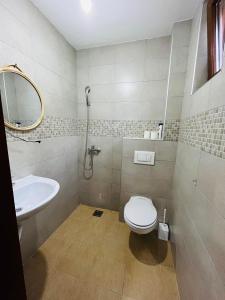 a bathroom with a toilet and a sink at Azra River View House in Bihać