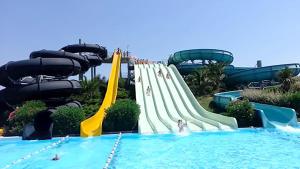 a water slide in a pool with people on it at VenuSuite VENOSA - Luxury House, Spa & Relax - in Venosa