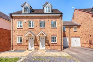 a brick house with white doors and windows at NEC Exhibitor Home, Stay near Birmingham Airport in Birmingham