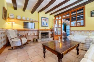 a living room with a table and a fireplace at Bonastre in Bonastre