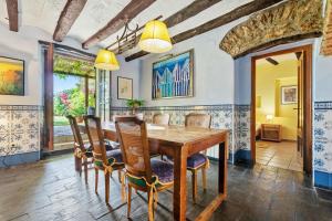 a dining room with a wooden table and chairs at Bonastre in Bonastre