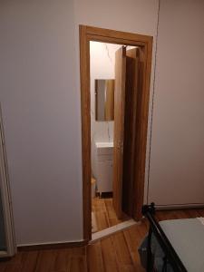 una puerta abierta a un baño en una habitación en kirkis apartment, en Ágios Rókkos