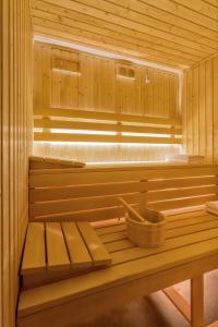 a wooden sauna with a bench in the middle at Royal Plater in Łeba
