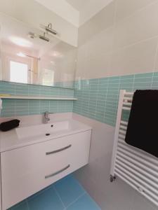 a white bathroom with a sink and a mirror at Chambre à louer 15mnn de Grenoble-salle de bain privée-WIFI gratuit in Fontanil-Cornillon