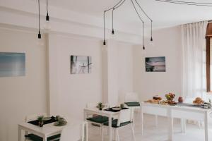 a white living room with white tables and chairs at MAF B&B in Cupello