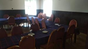 a row of tables and chairs in a room at Penzion Sportka 