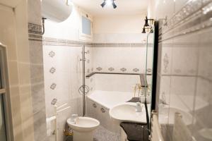 a small bathroom with a sink and a toilet at Belvedere in Tagliacozzo +27 photos