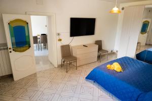 a bedroom with a blue bed and a flat screen tv at Belvedere in Tagliacozzo