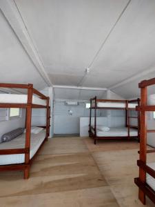 a room with three bunk beds in it at Angso Duo Resort in Pariaman
