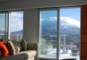 a living room with a couch in front of a window at The Setsumon in Kutchan +66 photos