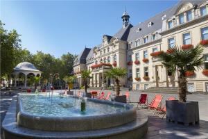 a large fountain in front of a building at Hôtel La Charbonnade in Dudelange