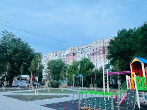a playground in front of a large building at 2-х комнатная квартира #Inamstro Apartament cu 2 camere cu TERASA in Chişinău