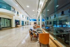 a lobby with chairs and tables in a building at Siva Sharm Resort & SPA - Couples and Families Only in Sharm El Sheikh