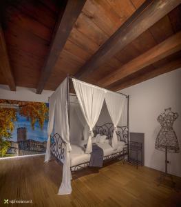 a bedroom with a bed with a canopy at B&B Gli Scorci di Trento in Trento