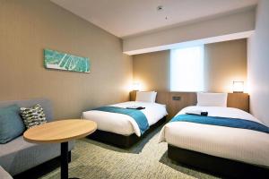 Postel nebo postele na pokoji v ubytování Hotel Intergate Hiroshima