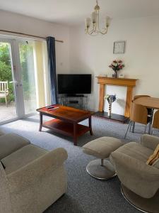 a living room with a couch and a coffee table at Family Bungalow sleeps 4 in Wellington