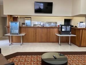 two laptops sitting on tables in a room with a bar at Inspirations Mullewa in Mullewa