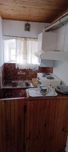 a kitchen with a sink and a stove top oven at Athina Country House in Kouramádes