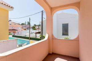 a balcony with a view of a swimming pool at ALTIDO Superb house with garden and patio in Charneca