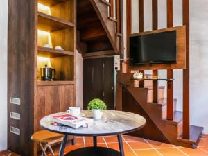 a small table with a tv in a room with a staircase at Carnarvon Antique Loft in George Town