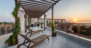 a balcony with two benches and a view of the ocean at Vello Apartments in Byala