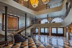 a lobby with stairs and a clock on the wall at Movenpick MS Sunray Nile Cruise 4 / 7 Nights Each Thursday From Luxor - 3 Nights Each Monday From Aswan in Luxor