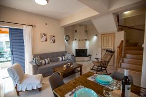 a living room with a couch and a table at Ada's House 2 in Mytikas