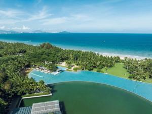 an aerial view of a resort with a pool and the ocean at The Sanya EDITION in Sanya