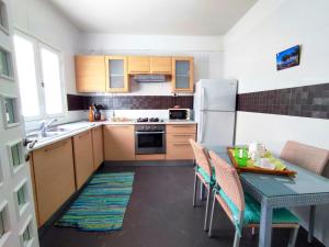 a kitchen with a table and a refrigerator at Appartement richement meublé a Sidi Bou Said in Sidi Bou Saïd