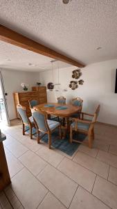 a dining room with a wooden table and chairs at Ferienhaus im Grünen in Kraase