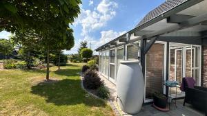 a house with a large white vase on the side of it at Ferienhaus im Grünen in Kraase +5 photos