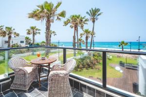 a balcony with a table and chairs and the ocean at Sea Life Nahariya BY Jacob Hotels in Nahariyya