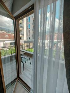 a balcony with sliding glass doors with a view of a building at Apartment Laterna in Budva