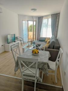 a living room with a table and a couch at Apartment Laterna in Budva