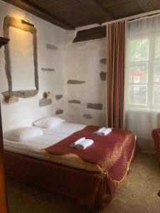 a bedroom with a bed with a red blanket and a mirror at Olevi Residents in Tallinn