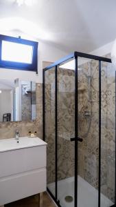 a bathroom with a shower and a sink at Affittacamere DOMO AGORA' in Tertenìa