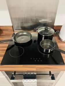 a stove top with two pots on top of it at #222 1 Bed Serviced Apartment in Derby