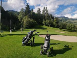 two scooters parked in the grass on a golf course at Ferienwohnung Aquileia in Scuol
