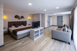 a hotel room with a bed and a couch at Avion Suite Hotel in Antalya
