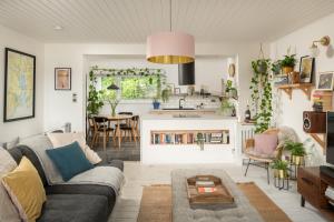 a living room with a couch and a table at Number 4 - Stylish 1 bedroom house in Truro, Cornwall in Truro