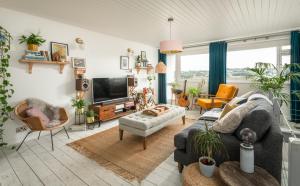a living room with a couch and a tv at Number 4 - Stylish 1 bedroom house in Truro, Cornwall in Truro