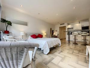 a bedroom with a white bed and a kitchen at Gray d Albion THI235 in Cannes +32 photos